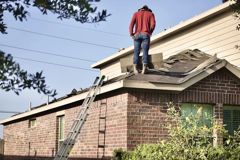 Professional roofer working on a residential roof in Lorfax Heights